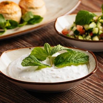 Mixed shallots and plain yogurt, garnished with mint leaves.