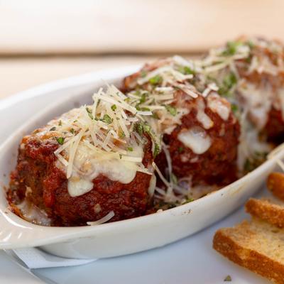 Meatballs and crostini, close-up view.