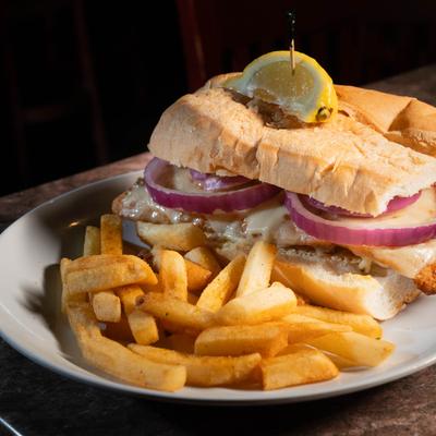 Blackened grouper sandwich, with slaw, Swiss, 1000 Island dressing, onion, and fries.