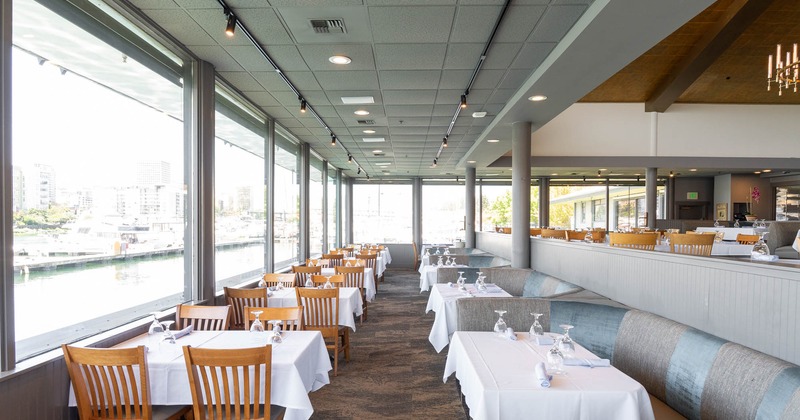 Interior of a bright restaurant, seating space, booths on the right