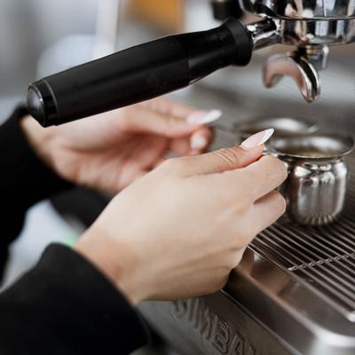 Hands preparing coffee.