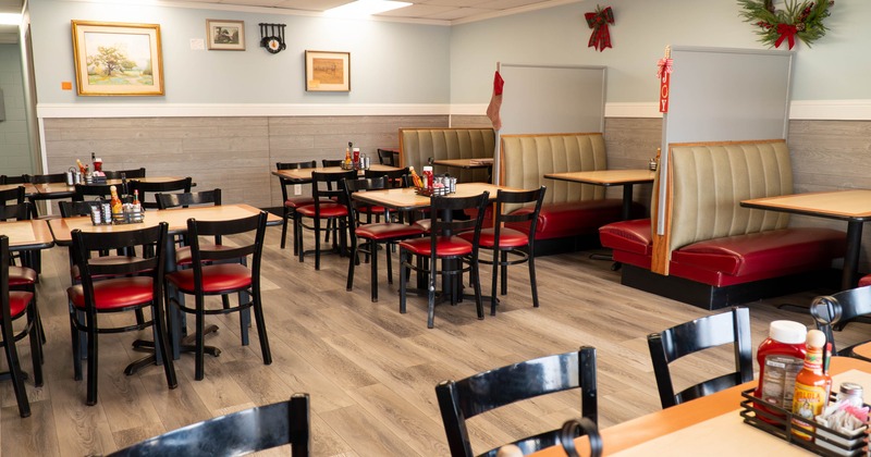 Interior of a diner with wooden floors, mix of tables and booths