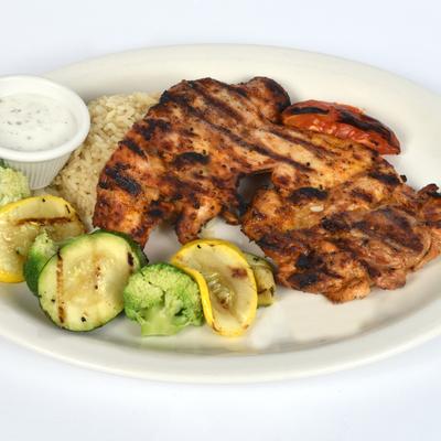Grilled chicken with rice and grilled vegetables.