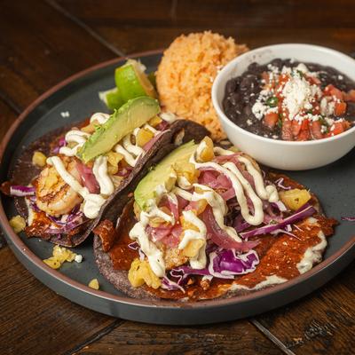 Wild - Caught Shrimp tacos served with rice and black beans.