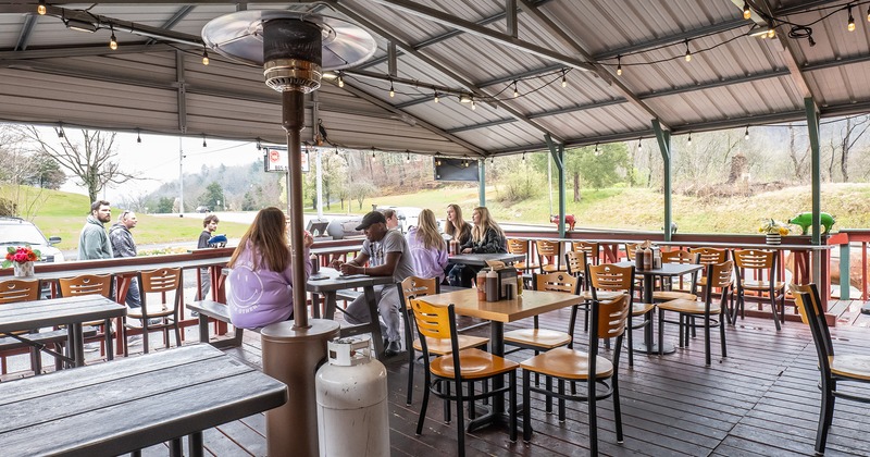 Covered patio, seating area, guests chatting