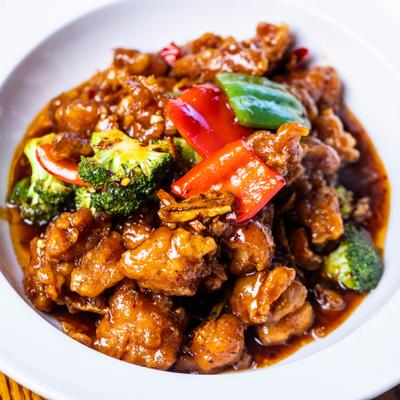 Orange chicken with broccoli and red peppers.