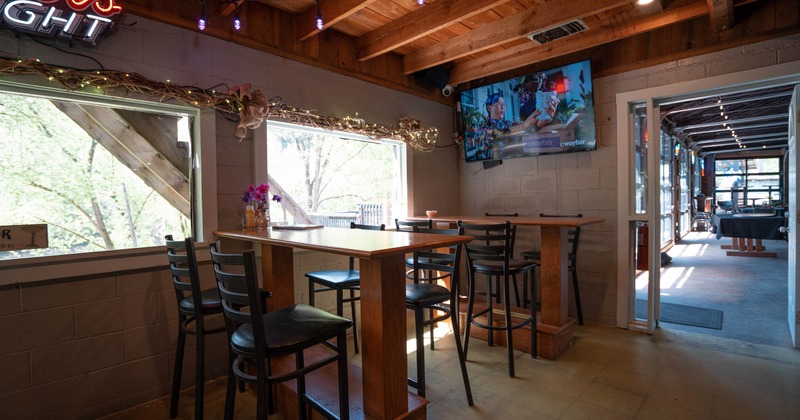 Interior, tall tables and bar stools next to the window