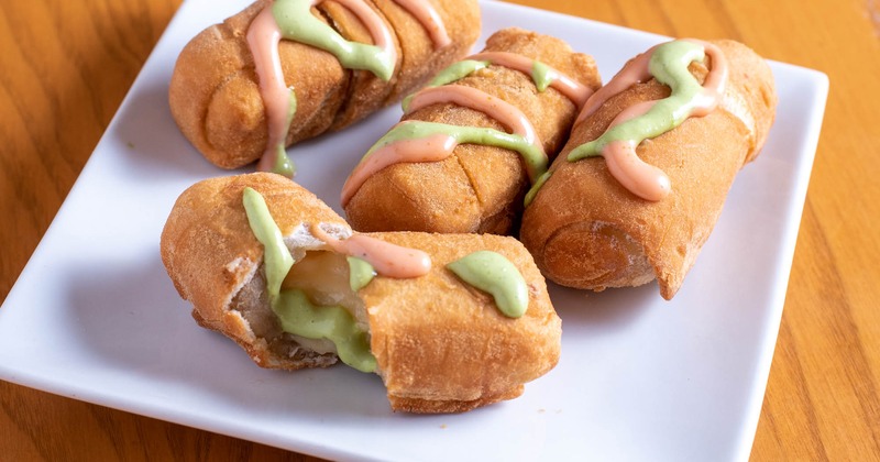 Fried breaded cheese sticks, topped with dressings