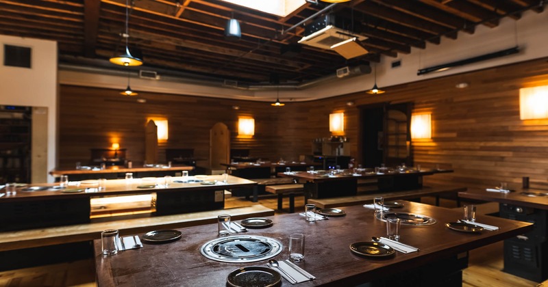 Dining area with a modern, somewhat rustic design and warm lighting