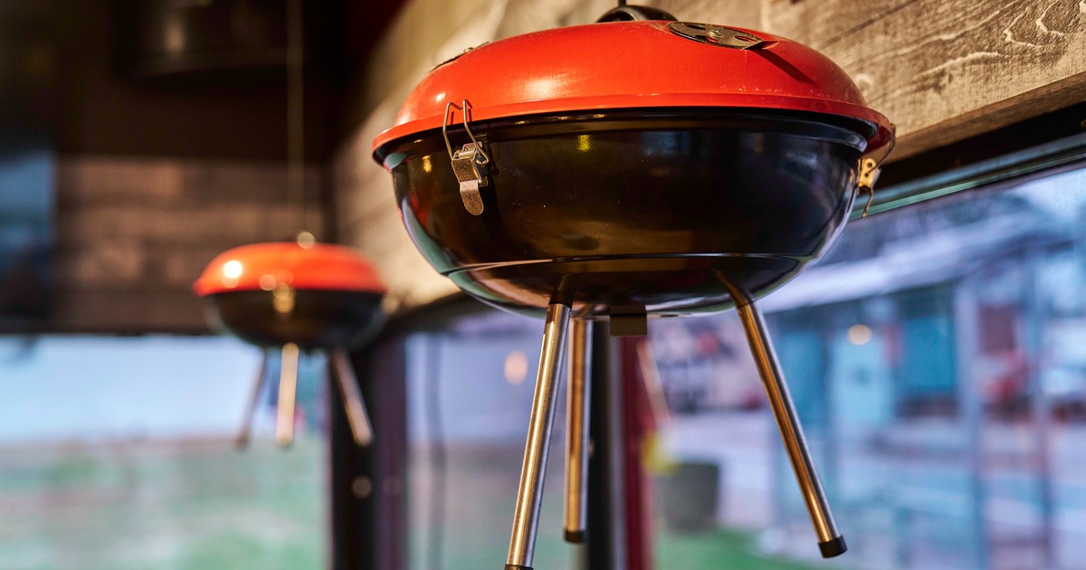 Interior, kettle grill hanging from a ceiling near windows