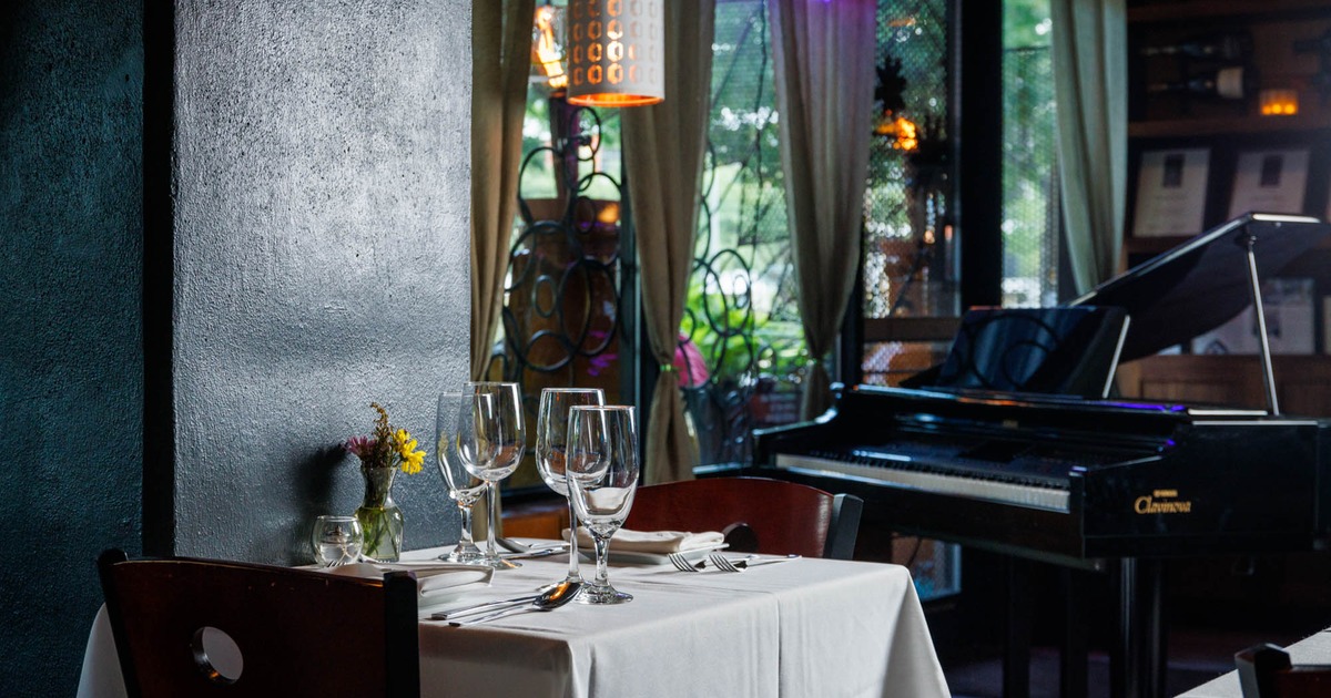 Table ready for guests, piano in the back