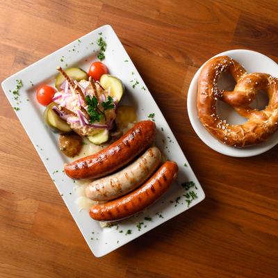 Sausages, salad, and a pretzel.