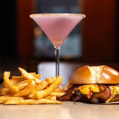 Burger with pimento cheese, bacon, pickled onions, fries, and a Lavender Lemon Drop.