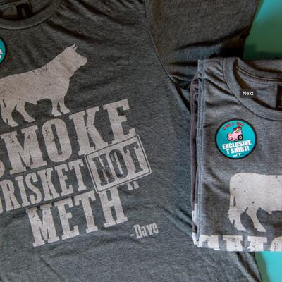 Gray t shirts with a graphic of a bull and the text, smoke brisket not meth - Dave.