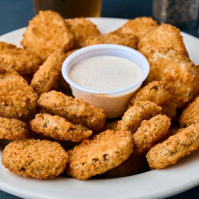 Fried pickles served with dipping sauce.