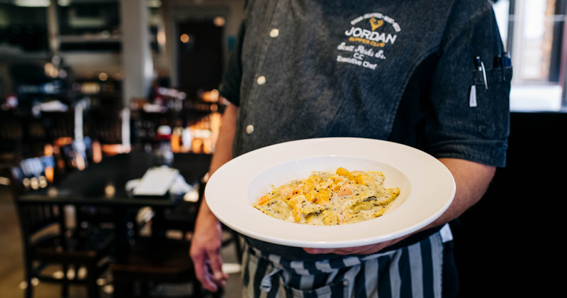 Waiting staff holding a plate with a dish