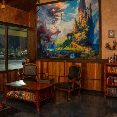 Armchairs, wooden table, and a bookshelf.