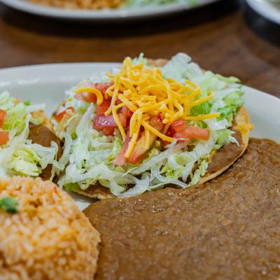 Bean and cheese chalupas served with refried beans and rice.