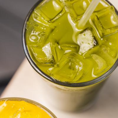 Iced green juice in a glass, close up.
