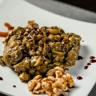 Spread with herbs, olives, walnuts, garlic, and pomegranate.