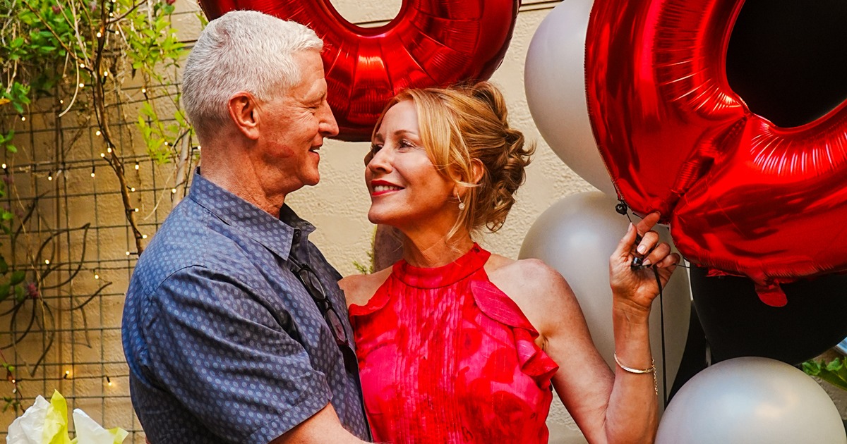 Warmly lit restaurant interior with hanging greenery and set tables