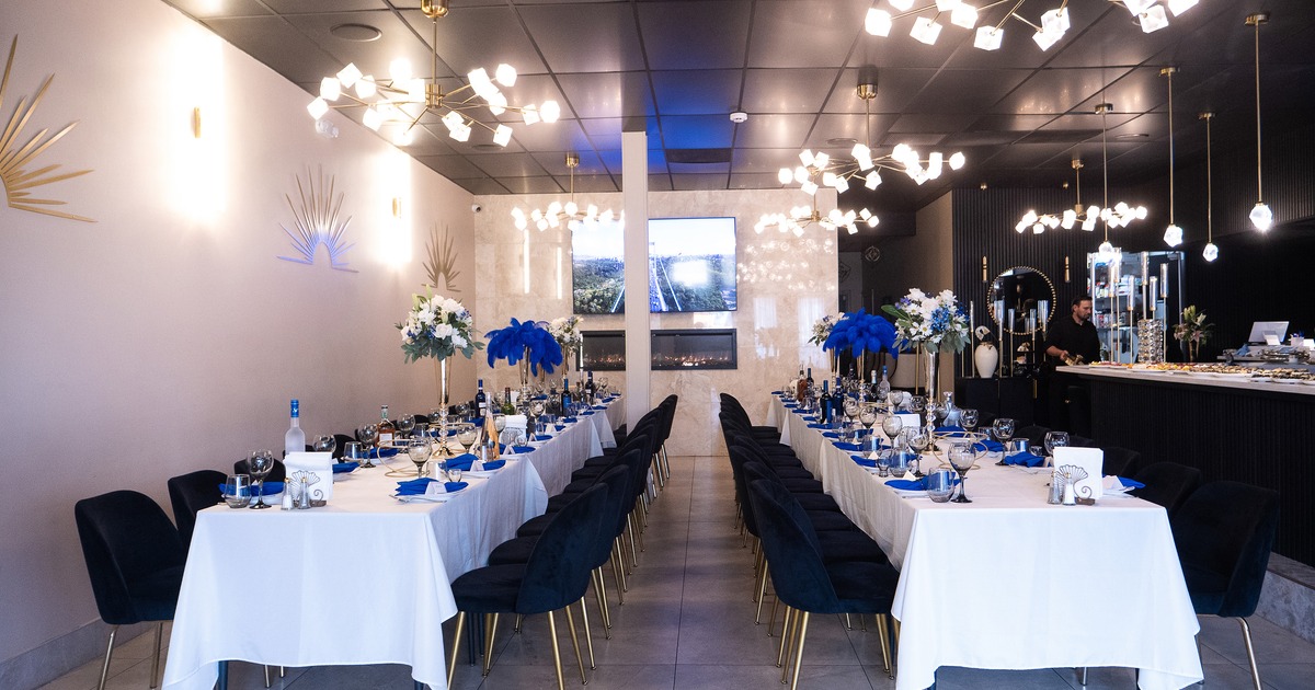 An elegant and cozy event space with set tables prepared for a celebration