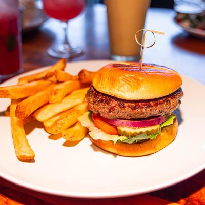 Pier 16 burger, served with fries, front view.
