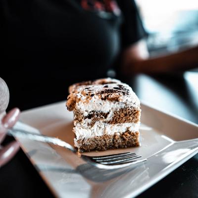 Tiramisu plate held by a server.