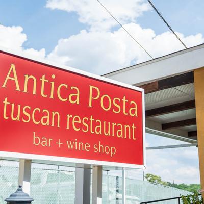 Red restaurant sign above the storefront.