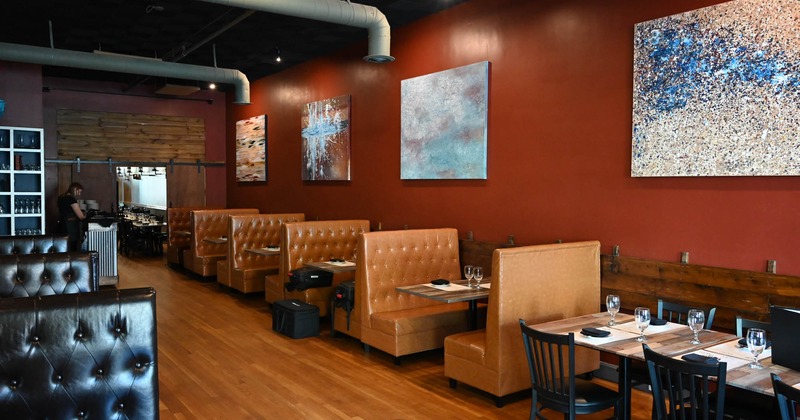 Interior, dining area, seating booths with tables, ready for guests, large format paintings