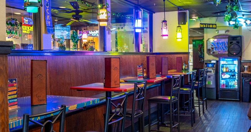 Interior, seating area illuminated by multicolored hanging lights