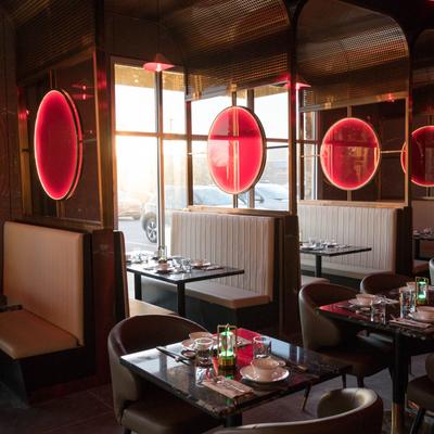 Restaurant interior, tables set for dining, booths, and chairs.