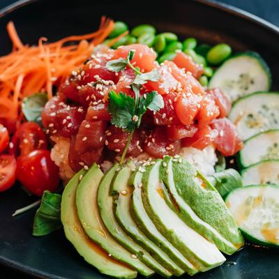 Tuna Poke Bowl, with cucumber, avocado, edamame, carrots and sesame seeds.