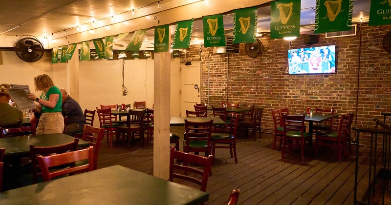 Dining area with TV on the wall of bricks