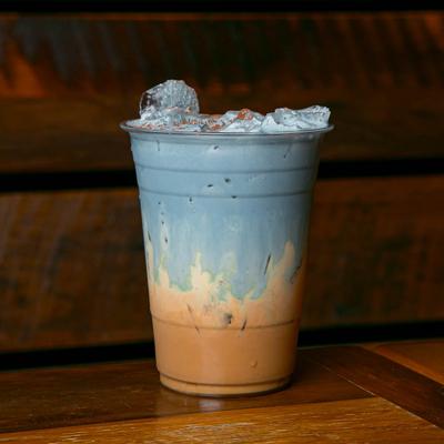 Butterfly Pea Vietnamese Coffee on a wooden table.