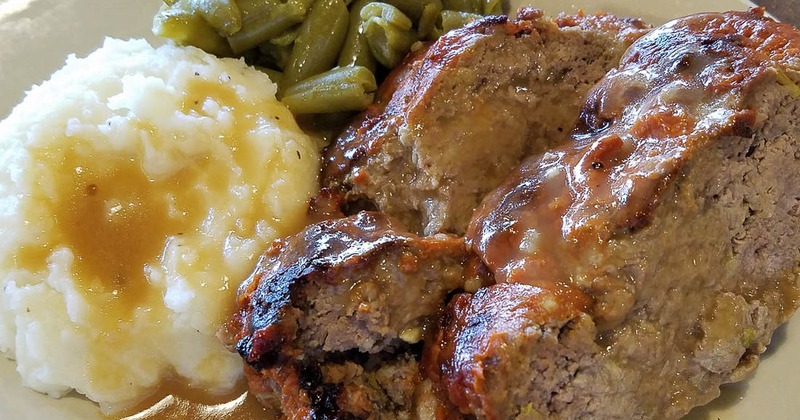 Meatloaf served with mashed potatoes and green beans