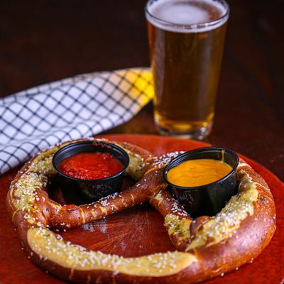 Jumbo pretzel with dips and a glass of beer