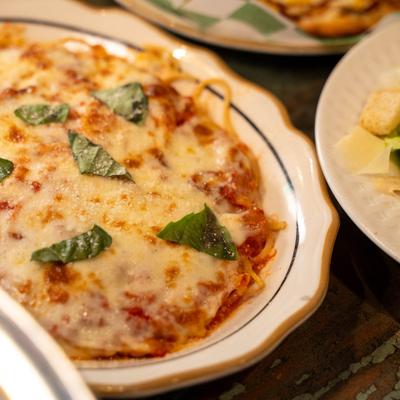 Baked spaghetti with tomato sauce and cheese.
