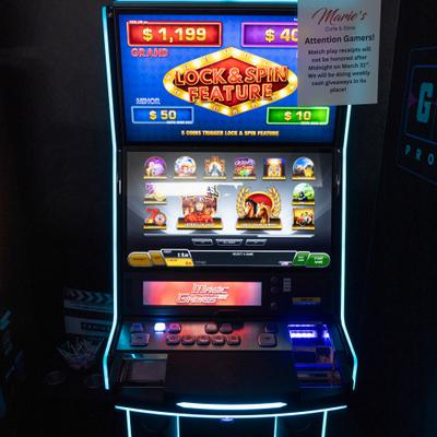 Casino slot machine with colorful screen, game icons, and control buttons.