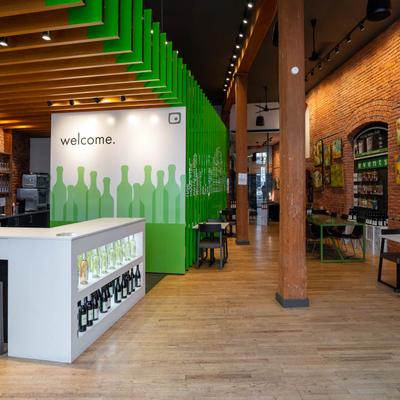 Interior space, counter with displayed wine bottles, seating  sspace.