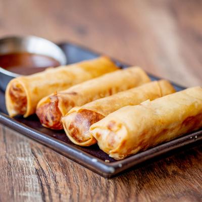 Fried spring rolls served with a dipping sauce.