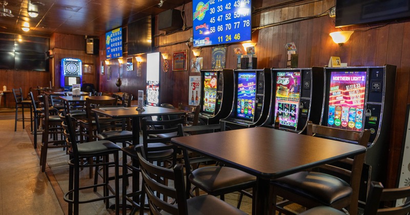 Interior, tables, chairs, slot machines, TVs on the wall