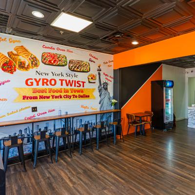 Interior featuring wall murals of the Statue of Liberty and various menu options.