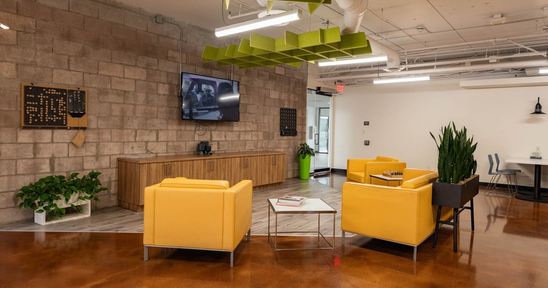 Lounge area with large TV screen on the wall