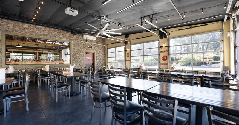 Interior, tables, chairs, booths, windows, LED screens, lights, counter