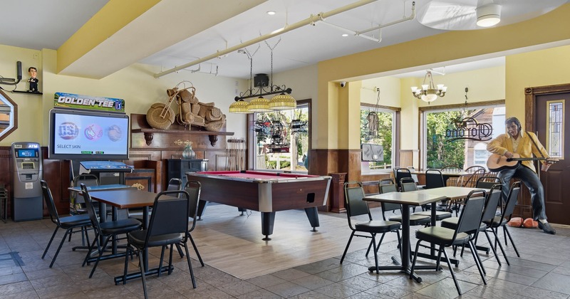 Interior, tables and chairs around pool table