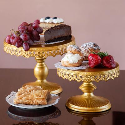 Assorted desserts displayed on golden stands with fruit garnish.