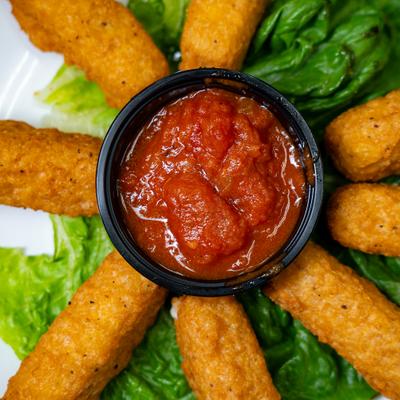 Mozzarella Sticks served with marinara dipping sauce, close-up.