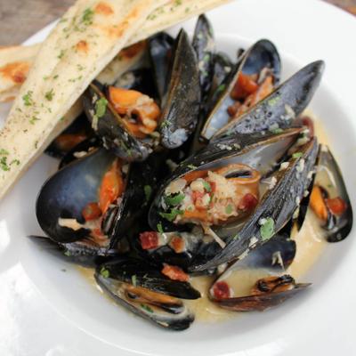 Mussels dish served with bread, close-up