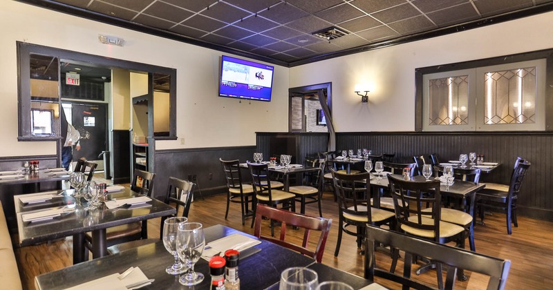 Interior, dining area, tables and chairs ready for guests, kitchen entrance